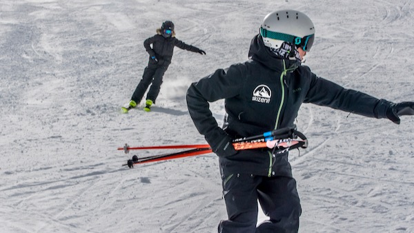 Ski instructor and skier on the slopes in Saas-Fee